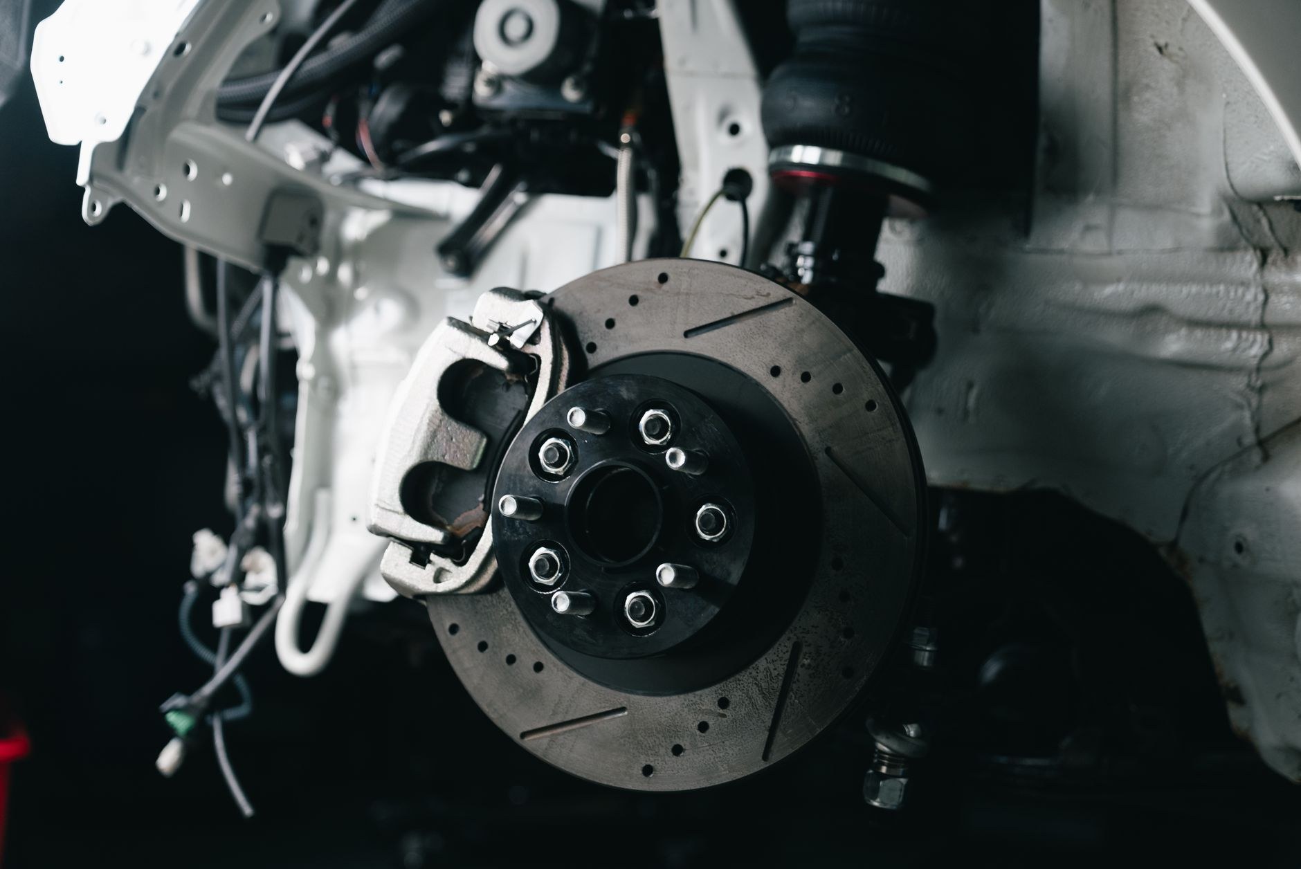 Underside view of a car suspension and exhaust run