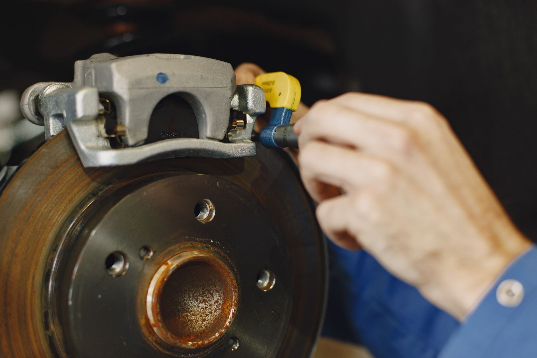 Hand adjusting a caliper with a tool during fault finding