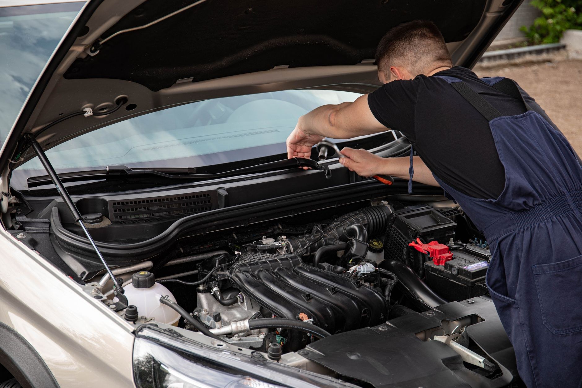 Mechanic checking a vehicle in the workshop during a warrant of fitness inspection
